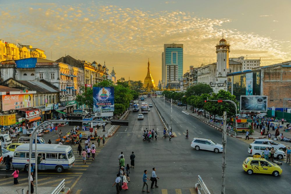 People walking on a pedestrian lane during the daytime in Yangon, Myanmar