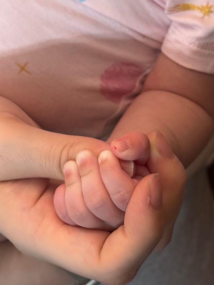 A baby’s tiny hand wrapped around my thumb