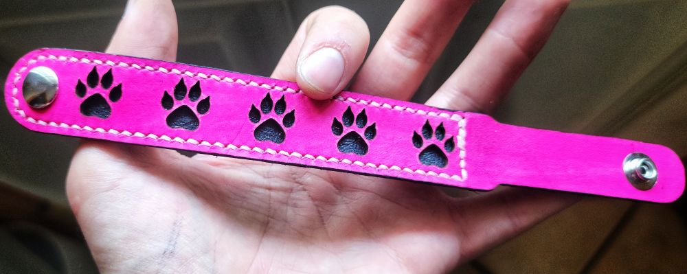 Pink Dog Paw Print Bracelet with snap closure.