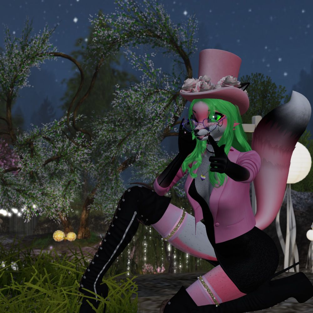 a feminine pink anthropomoric fox kneels with one knee raised. they point to the camera with their left hand, with the right brushing their long neon green hair out of their right blinking eye. their tounge is slightly sticking out, as their bright green eye looks at the viewer. they are wearing long over the knee boots. on the torso they are wearing a short black dress that has a very low cut neckline revealing a mesh covered mid section. a pink blazer jacket is worn over the dress. accessories include a nonbinary pride locket necklace, heart shaped glasses and a pink tophat with roses on it. behind them, in the distance is a pair of trees forming a heart. The sky shows it's night time.