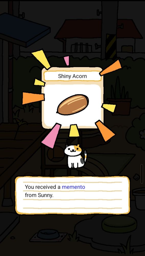 Sunny the cat from the game Neko Atsume has gifted a memento, a shiny acorn. The illustration of the shiny acorn has yellow, orange and pink highlights around it and Sunny sits proudly underneath.