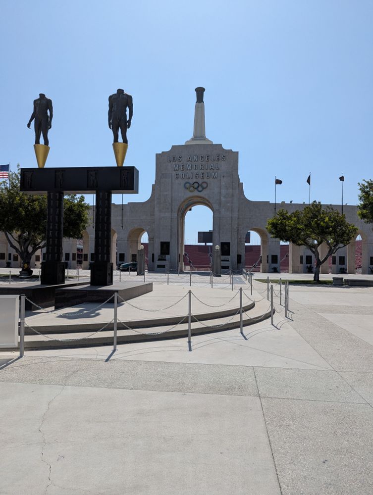The peristyle entrance to and Olympic torch over the LA Coliseum