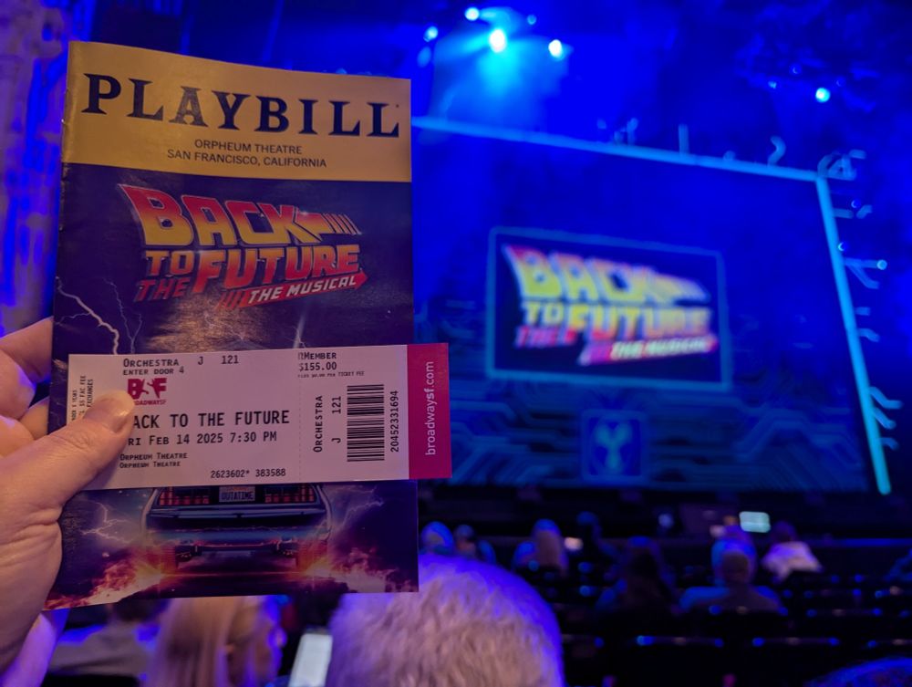 Program, ticket, and high-tech-looking curtain for Back To The Future The Musical.