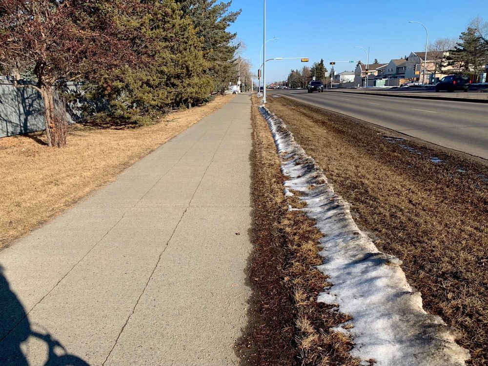 March 13, 2024: a shared-use path along the north side of 167 Ave, in full sun. The path is dry and clear because it gets prolonged sun exposure.