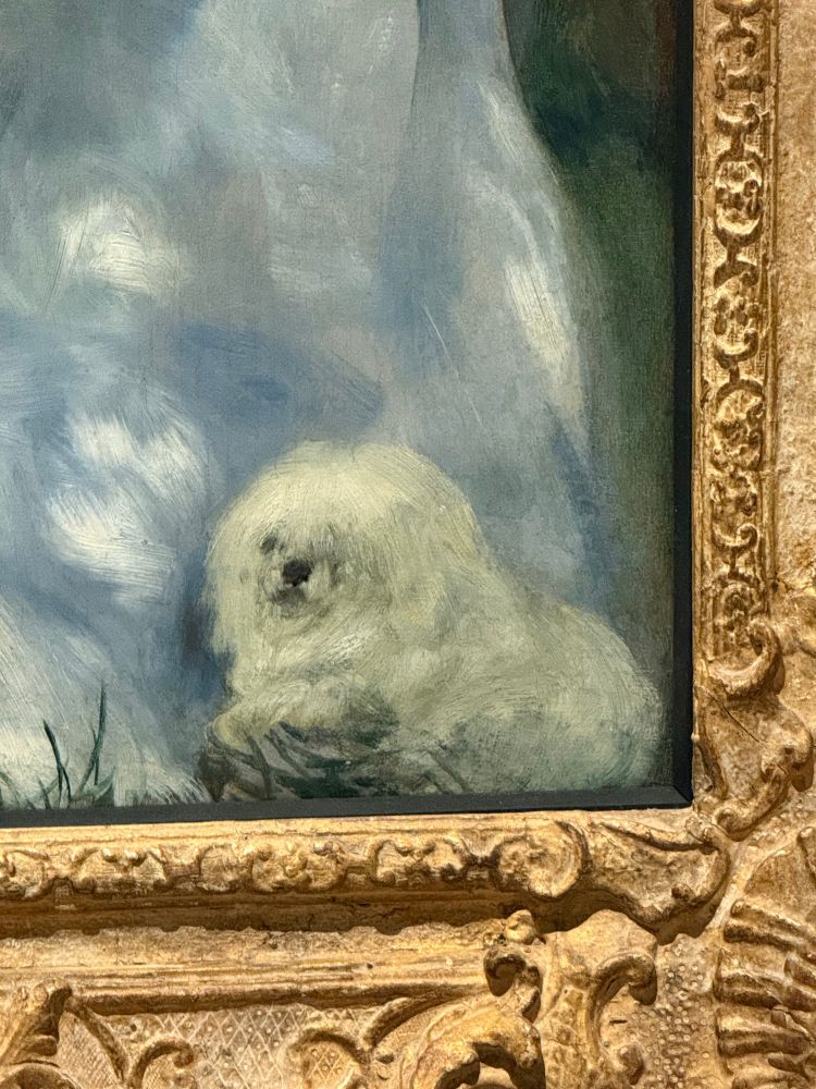 The lower-right corner of Confidences by Pierre-Auguste Renoir, which features a fluffy white dog