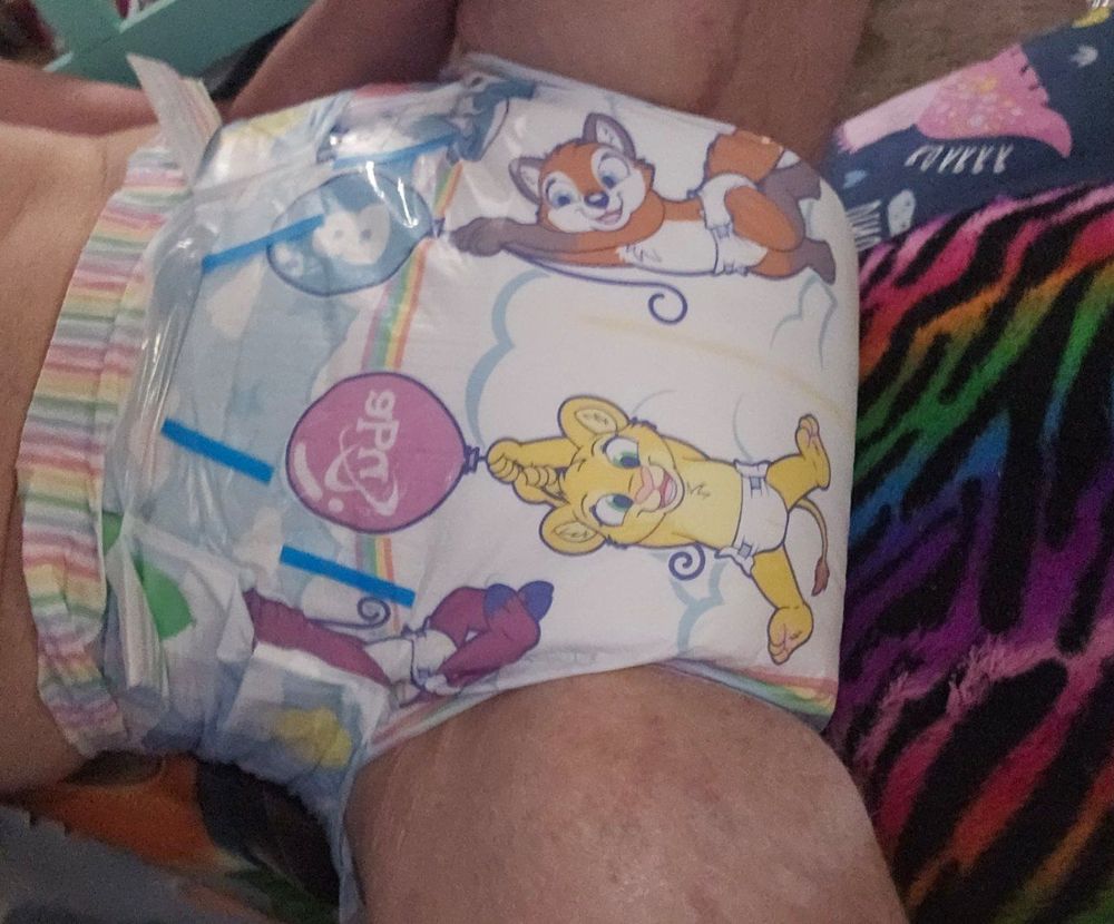 A crotch shot of a wide and thick (and dry!) Tiny Tails diaper on an adult. Showing how big and thick the diaper is before it is even used.