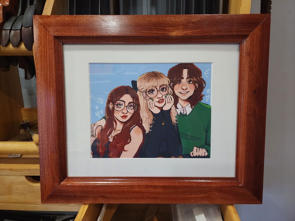 Hard to describe! My three kids drawn in my daughter's own style, framed with a Bloodwood frame. 