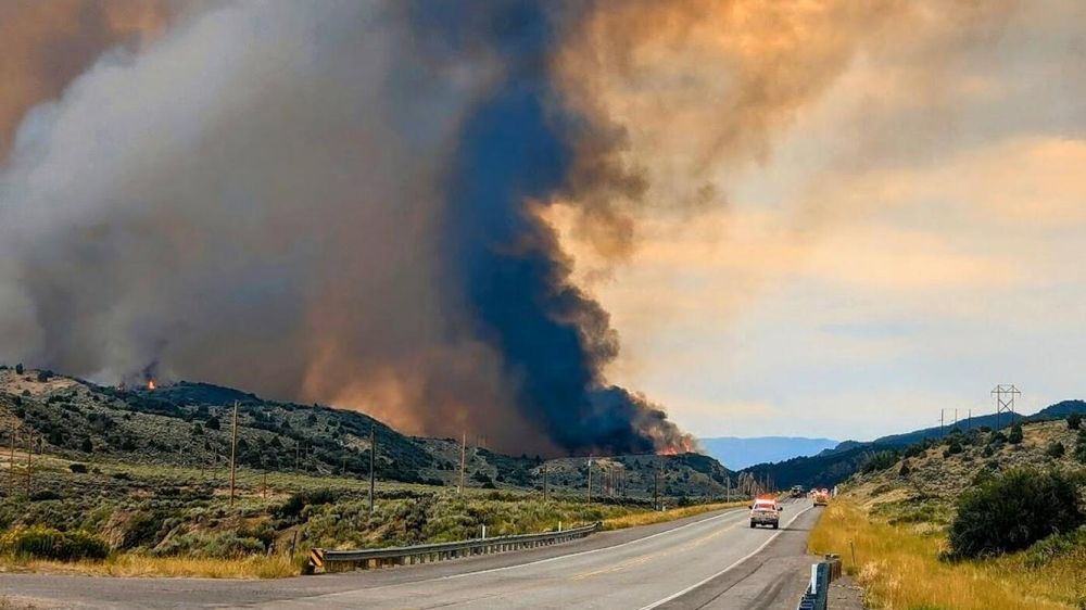 In western Colorado, firefighters are up against windy, hot weather as they try to protect homes and infrastructure from a pair of lightning-caused wildfires.