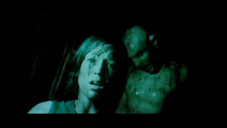 Pale-skinned mosnter sneaking up on a woman in a dark cavern. It's from a movie called the Descent.