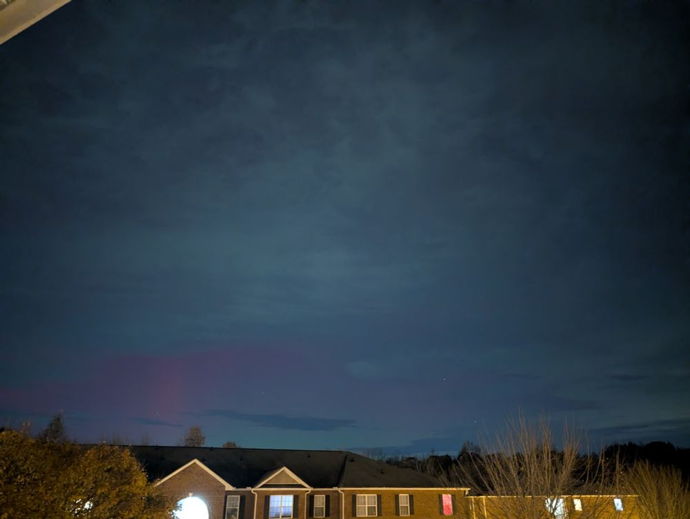 A view of the northwest sky with faint pink and green colors