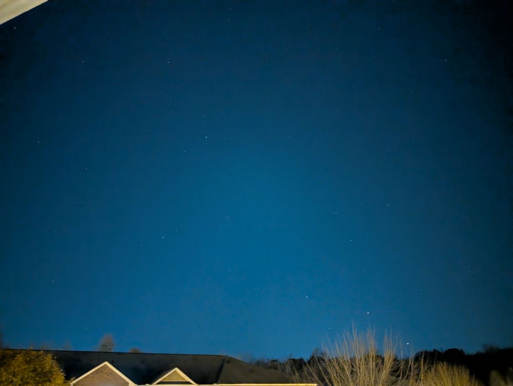 A look at the north-northwest sky showing the reflection of city lights and a few stars