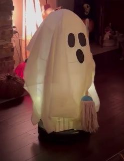 Rooma on wooden floor with ghost costume/prop on top of it