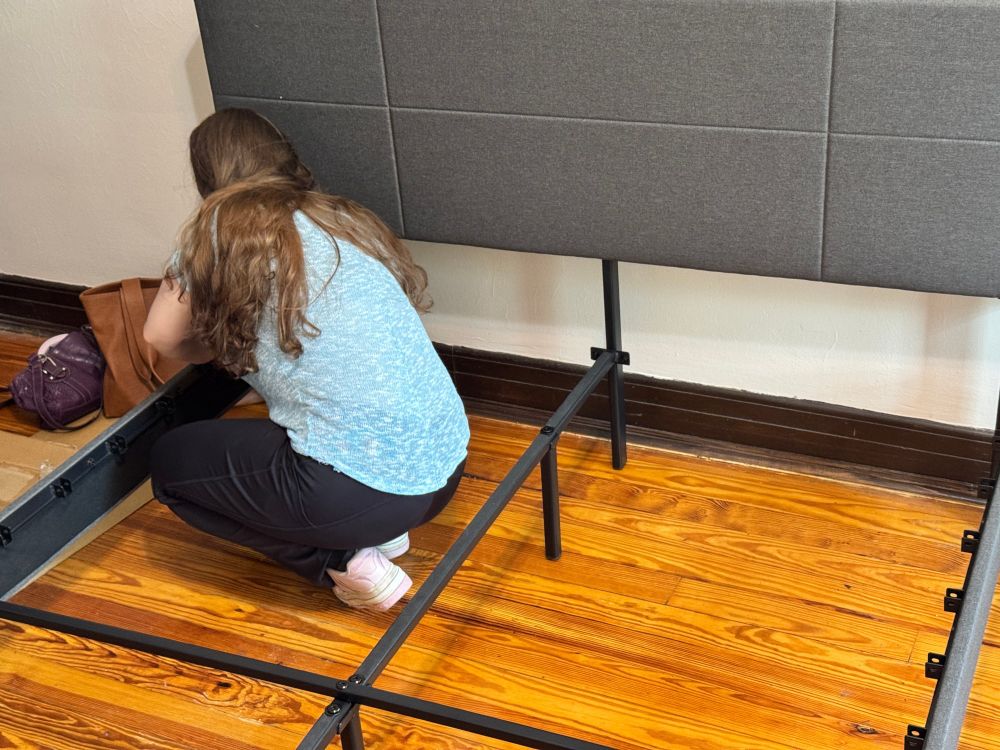 Tzipporah assembling a bed frame