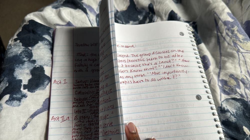 Photo of Ellie holding chunk of notebook pages.