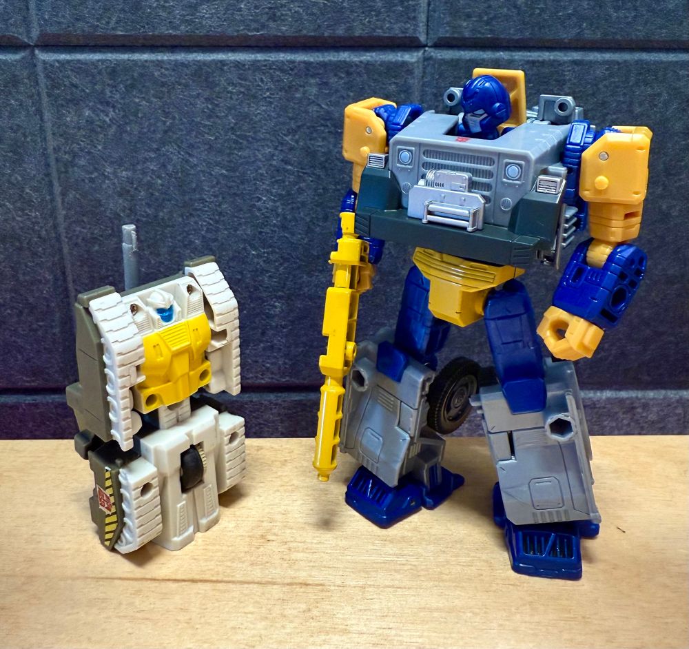 Generation 1 Guzzle figure next to Age of the Primes Fisitron (Ironfist).