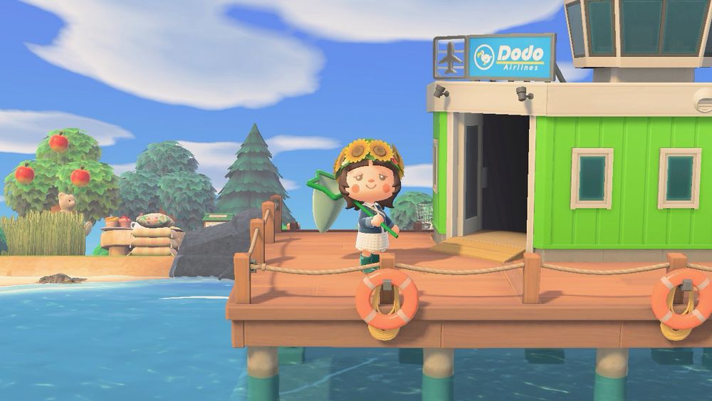 animal crossing new horizons screenshot of my character holding a green start net next to my green airport 