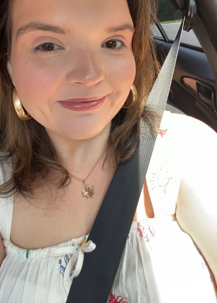 cate posing in a car 