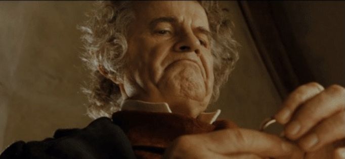 Still from The Fellowship of the Ring of Bilbo looking at the Ring, referencing the "After all, why not?" meme