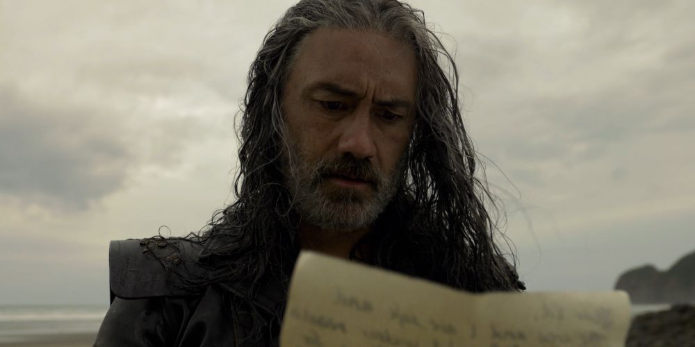 Close up of Ed’s face as he reads Stede’s letter on the beach.