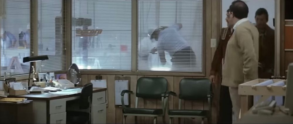 Scotty, the scientist and Dr. McCoy walking into a very 80s office