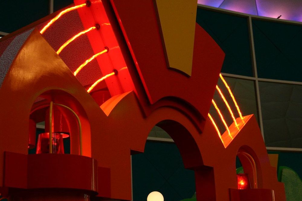 An arched column with bright red neon in the Sensory Funhouse exhibit in the Wonders of Life pavilion 
