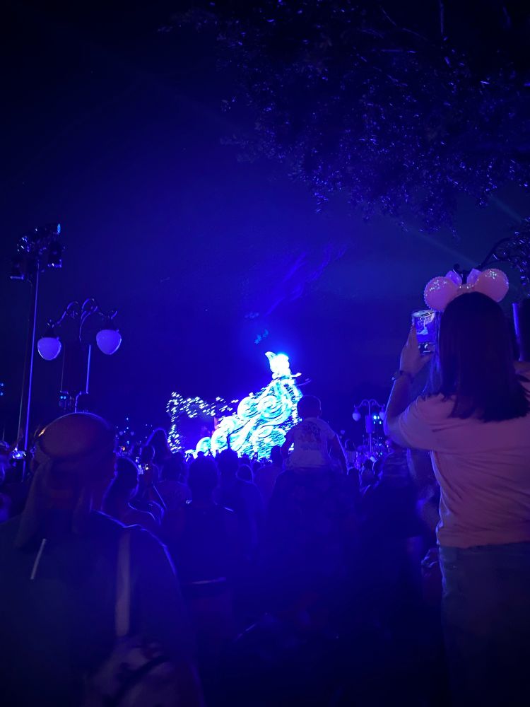 A blurry photo of the blue fairy float from the new Starlight parade at Magic Kingdom