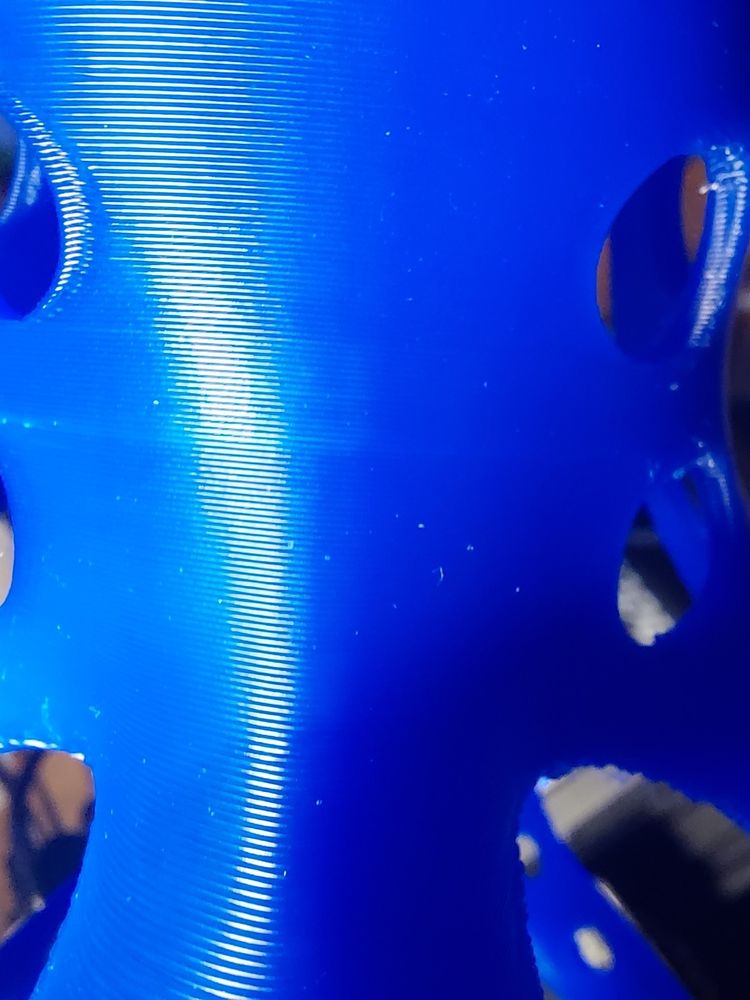 Unknown item of a blue colour, showing off clean 3D printer layer lines 