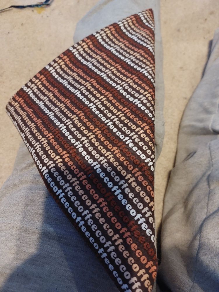 A bandana that reads "coffee" all over