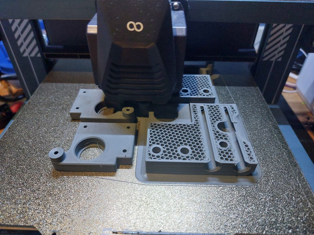 An Elegoo printer printing parts for another printer
