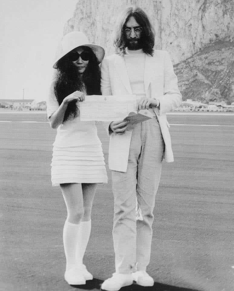 John and Yoko, in white, after getting married in Gibraltar.