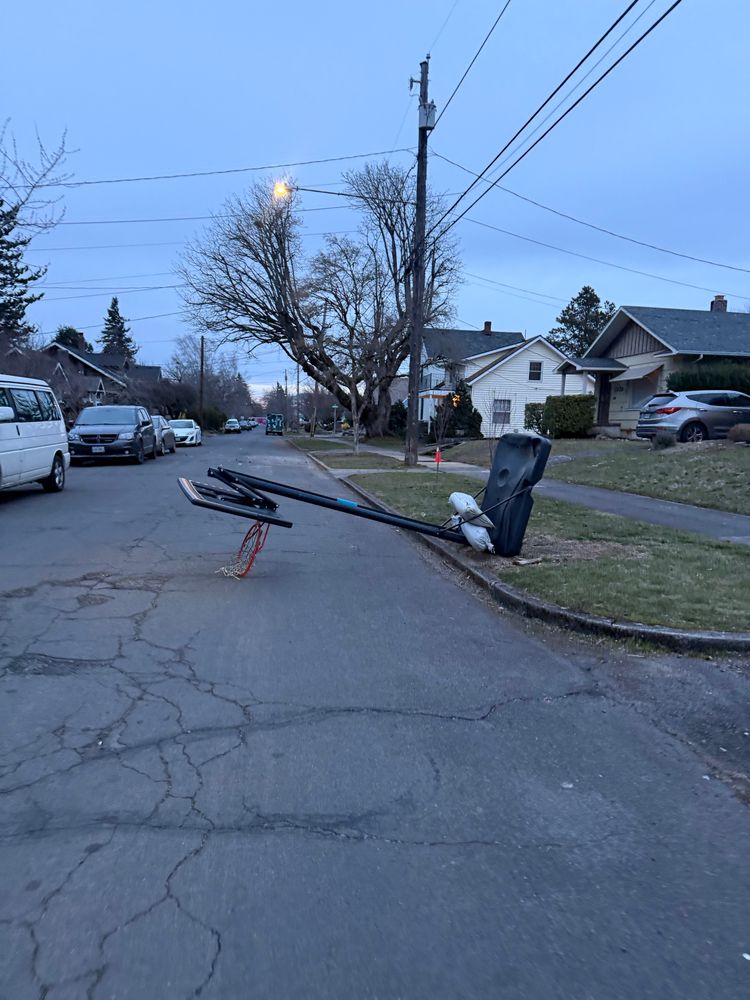 Basketball hoop blown over into street.