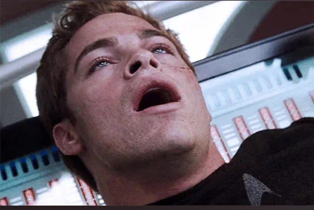 AOS Jim Kirk recovering from being choked by Spock but it looks like an o face.