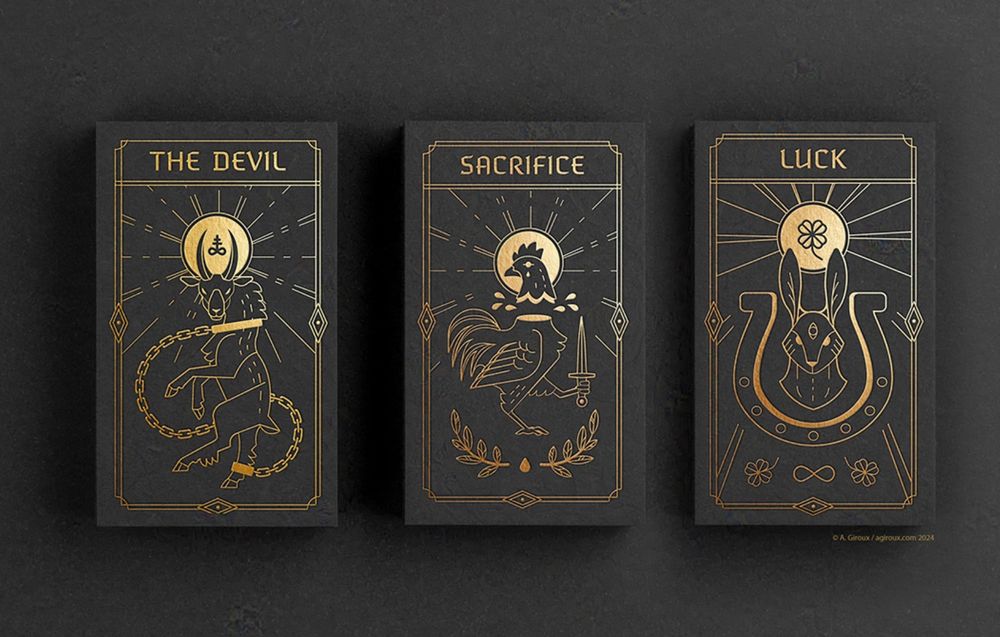Top down photo of three gold-on-black tarot cards, on a black background. Left to right, The Devil – depicting a goat on its hind legs, a chain around the body, with a golden disk above with a sulphur symbol in the middle. Then Sacrifice, a beheaded rooster, the knife in one clawed foot. The last, Luck, a rabbit head in the middle of an upright horseshoe. A gold disk behind the head, with a four lead clover in the middle.