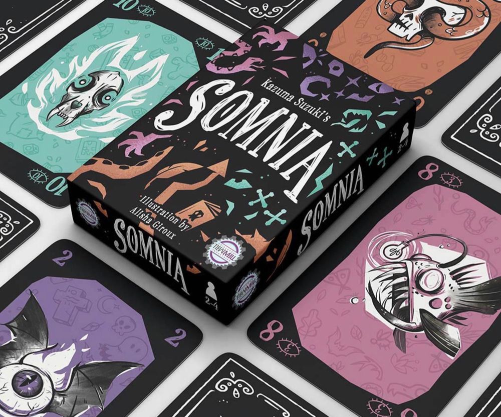 photo render of a card game and game box. Box reads SOMNIA, surrounded by sketchy, colourful spooky items like eyes, snakes, claws and tentacles. Surrounding the box are player cards, depicting creatures like angler fish, a wolf skill, winged eyeball, snake and skull etc. 