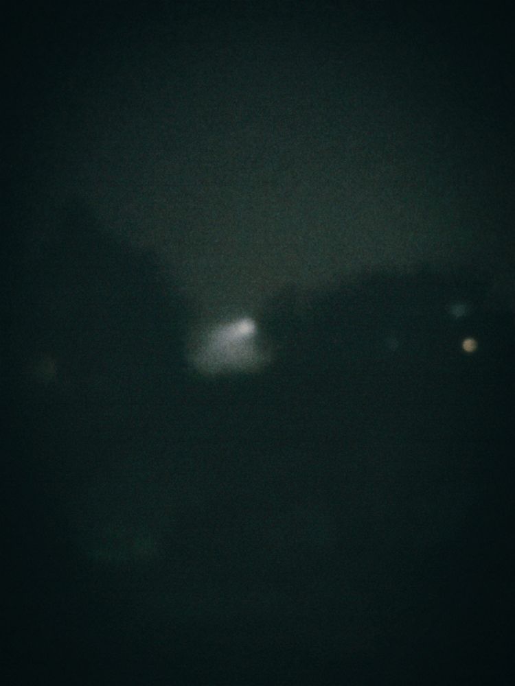 Blurry foggy photo with a light shining in the distance