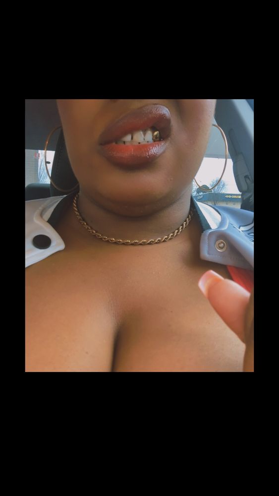 A pretty Black woman's lips looking juicy and full. 