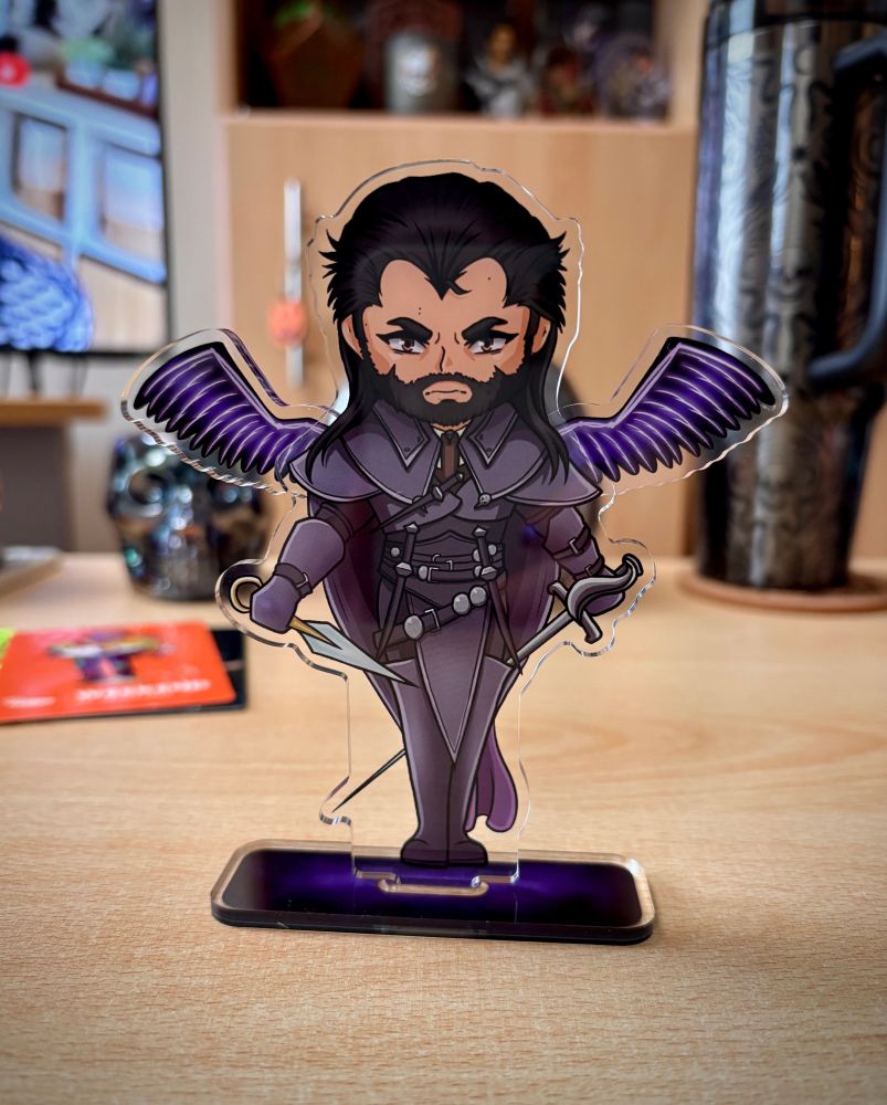 Photo of an acrylic standee of lucanis from dragon age the veilguard