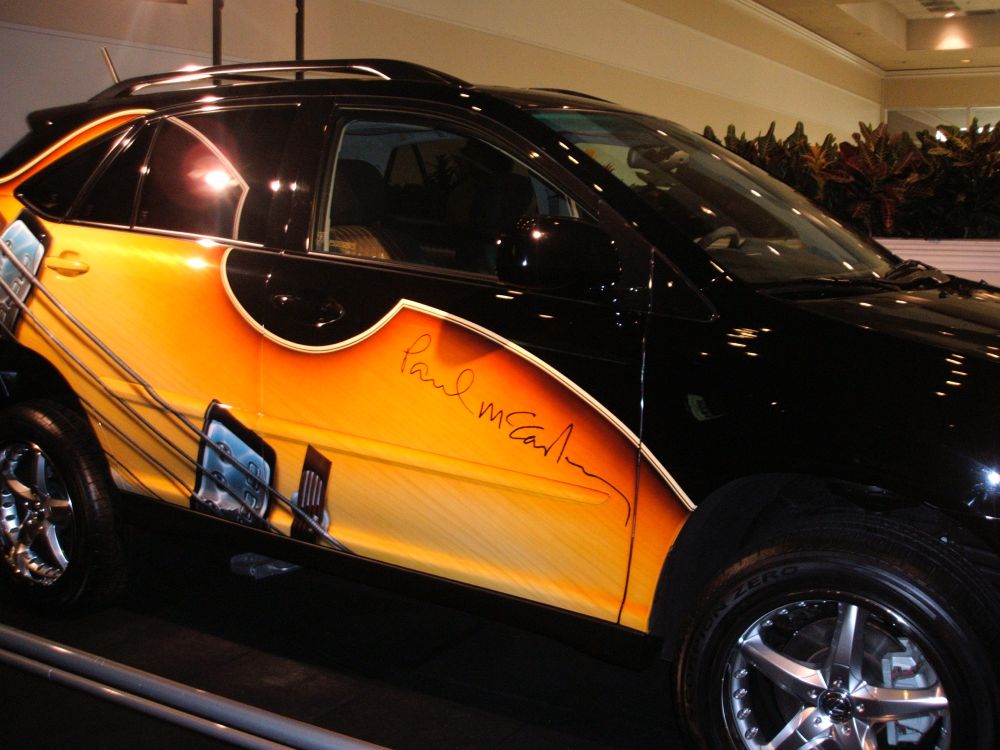 Photo of a Lexus car with a custom paul mccartney bass guitar wrap