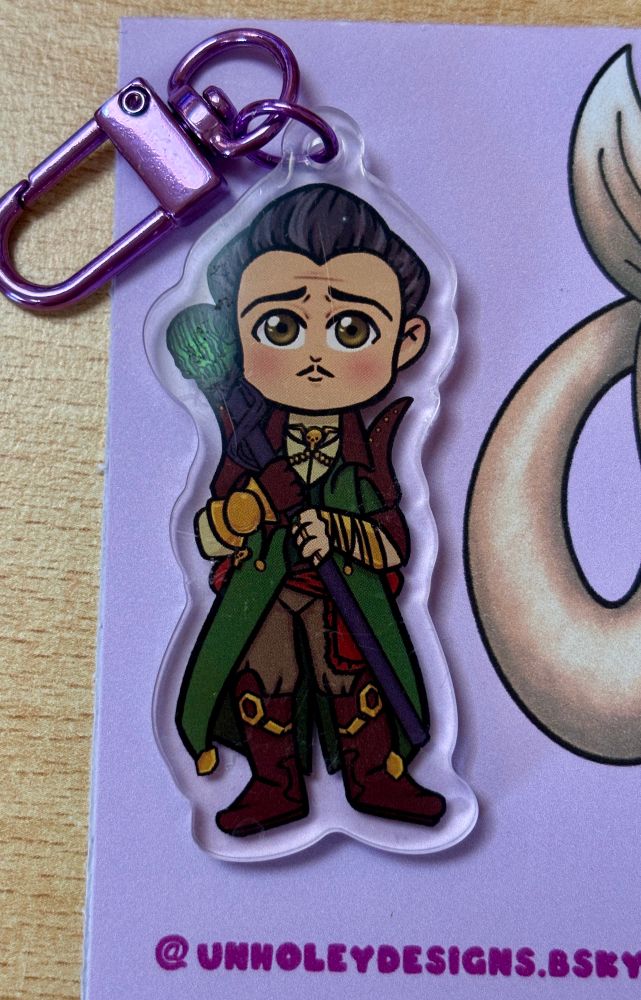 Photo of an acrylic charm of Emmrich from dragon age the veilguard 