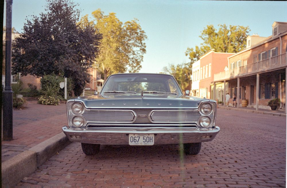 Blue old school Plymouth on film, from the front grill 