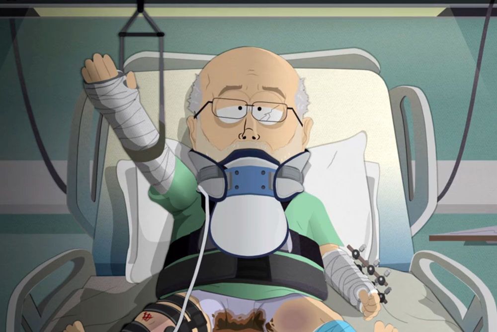 An image from the animation South Park depicting the chair of the FCC Brendan Carr pathetically excreted lose stool in his underwear, lying helplessly in a hospital bed with his arm in a Nazi salute.