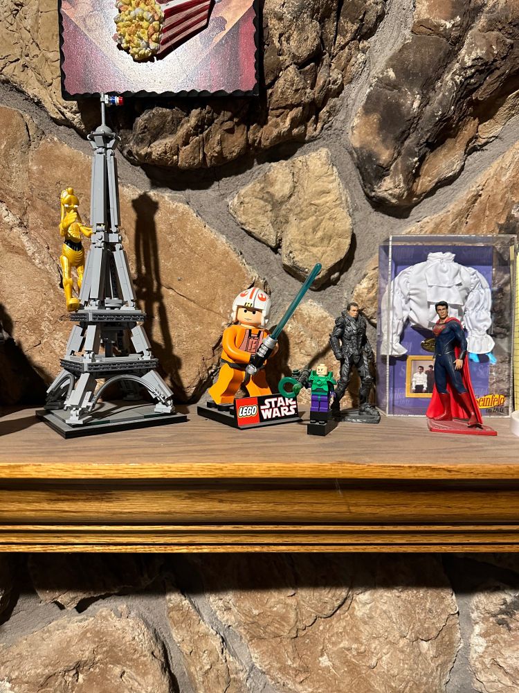Lego Luke Skywalker, Goofy-3PO on mini Lego Eiffel Tower (also Superman & Zod figurines, Lego Lex Luther with kryptonite gun, and Seinfeld puffy shirt)