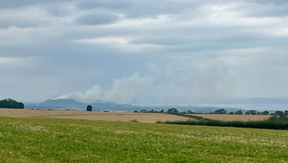 A fire burning on Arthur’s seat in the distance 