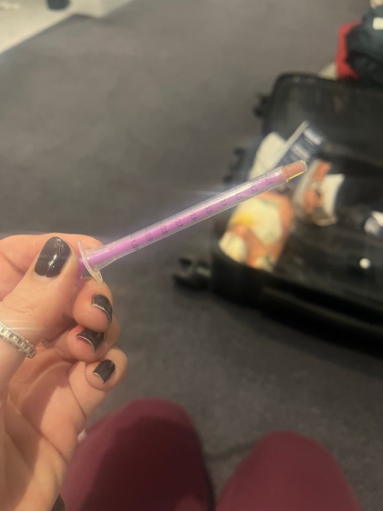 Holding the pipette from Curaleaf for the oil 