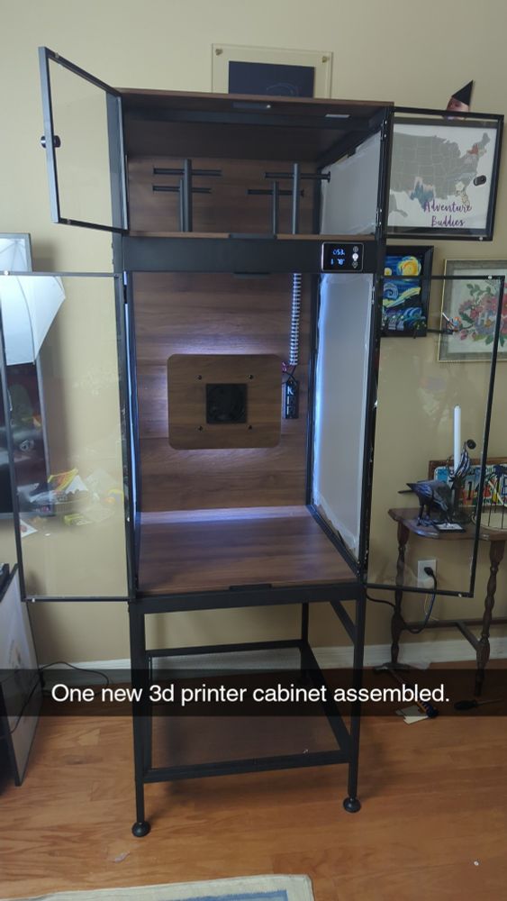 The Crafit 3d printer storage cabinet with the doors open. Text in the image saying "One new 3d printer cabinet assembled". 