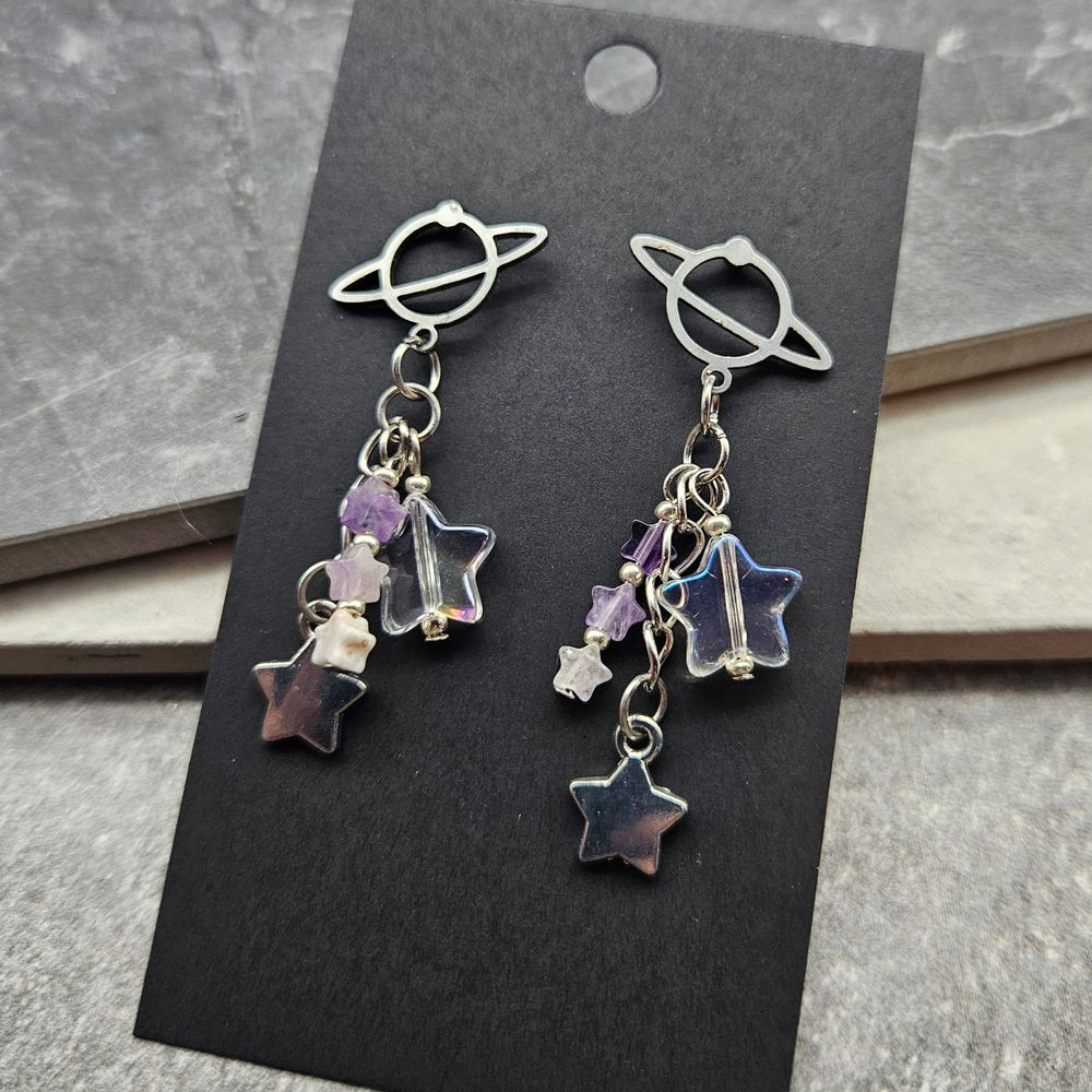Space earrings with dangles and purple beads.