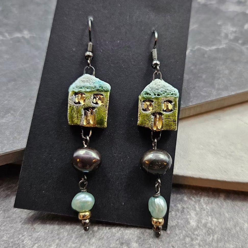 Green ceramic house earrings with midnight pearl and teal pearl accents. 