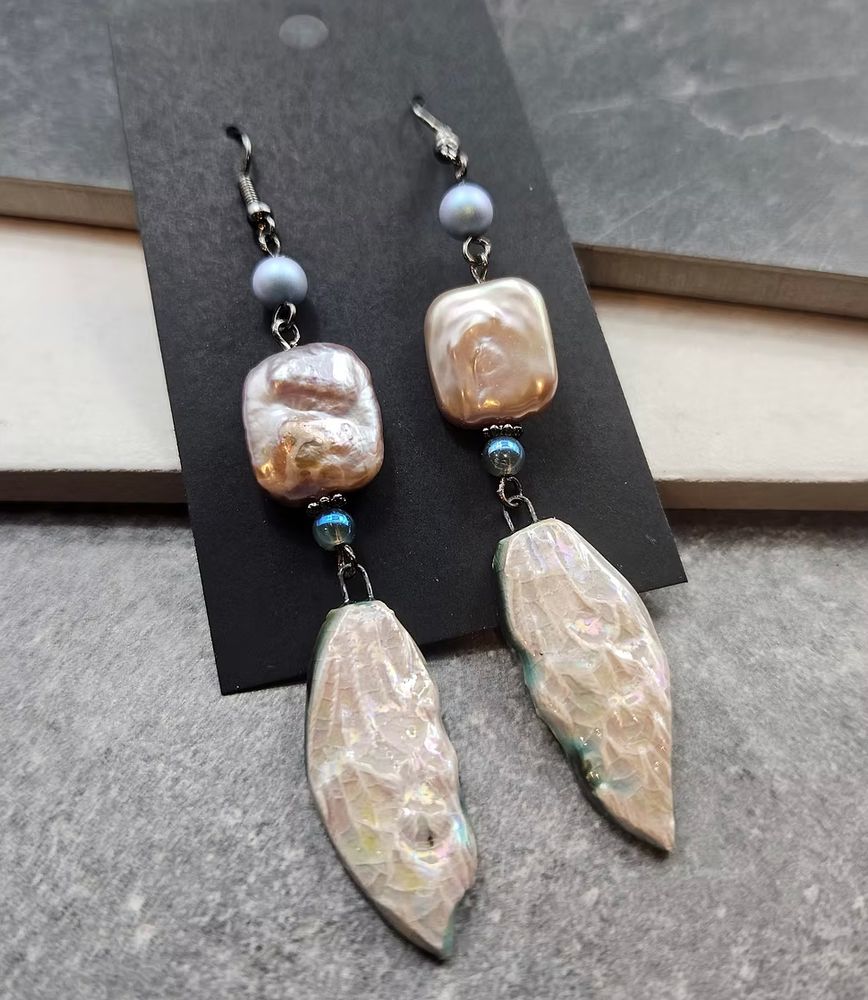 Pearl and ceramic wing earrings. 