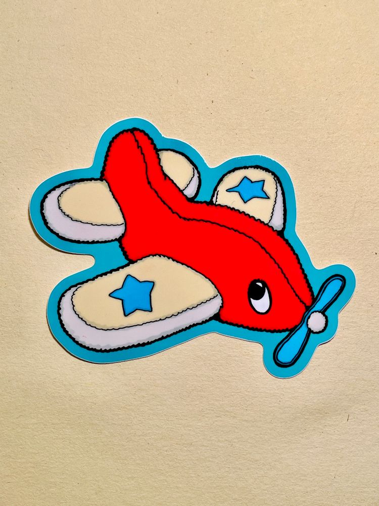 A sticker of a plush airplane, described more thoroughly on the next image. 