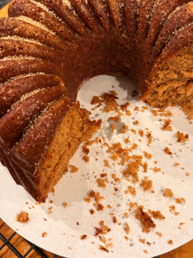 Cut Apple cinnamon doughnut cake on a cake liner